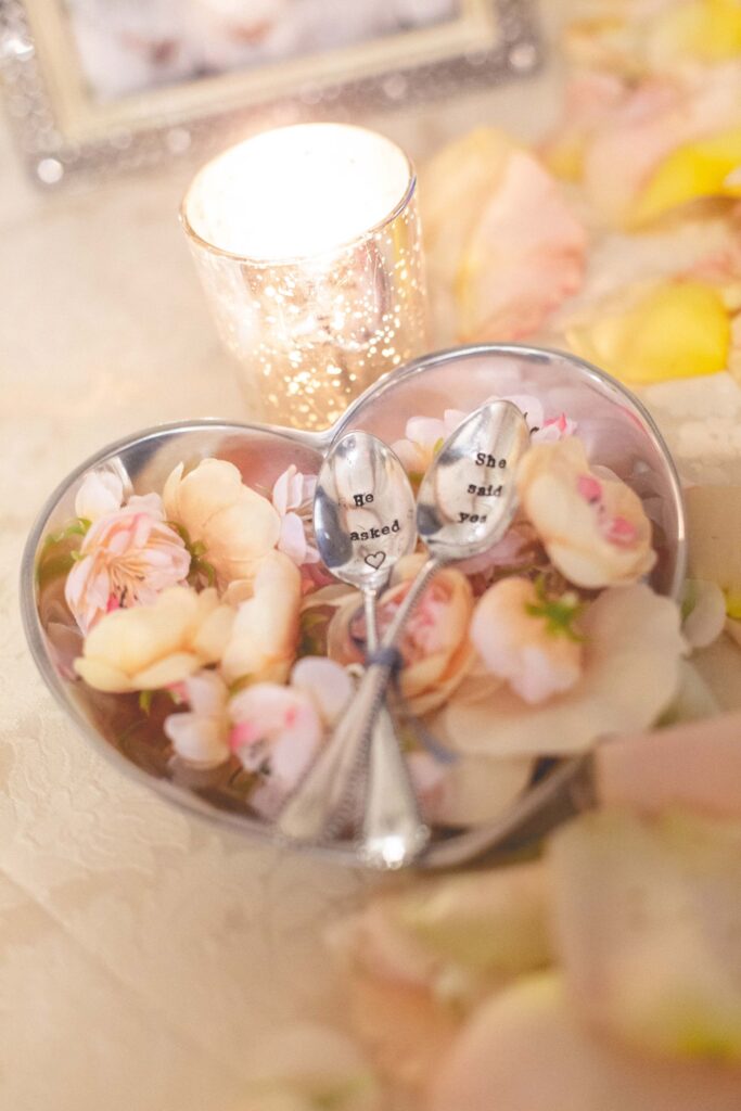 Wedding details of spoons with text 'he asked' and 'she said yes'